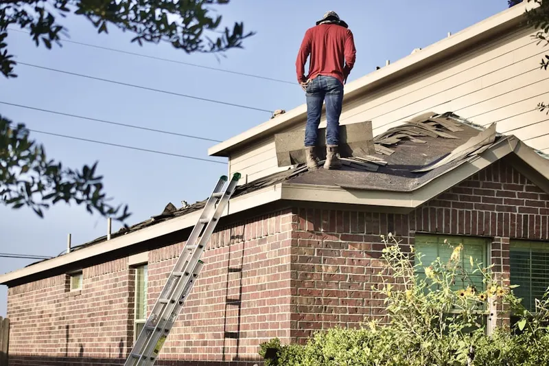 Professional roofer working on a residential roof in Sudbury
